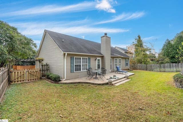 rear view of house with a yard and a patio