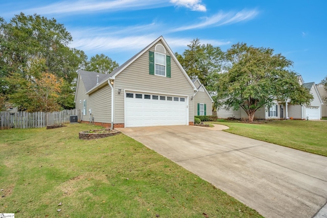 view of front of house with a front yard, central AC, and a garage