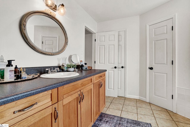 bathroom featuring tile patterned flooring and vanity