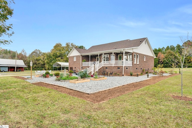 view of front of home with a front yard and covered porch