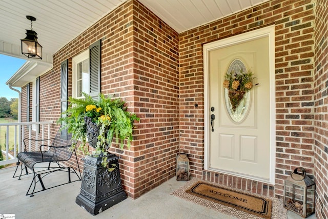 view of exterior entry featuring a porch