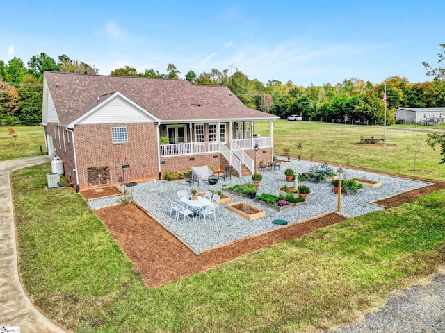 back of house with a yard and a patio area