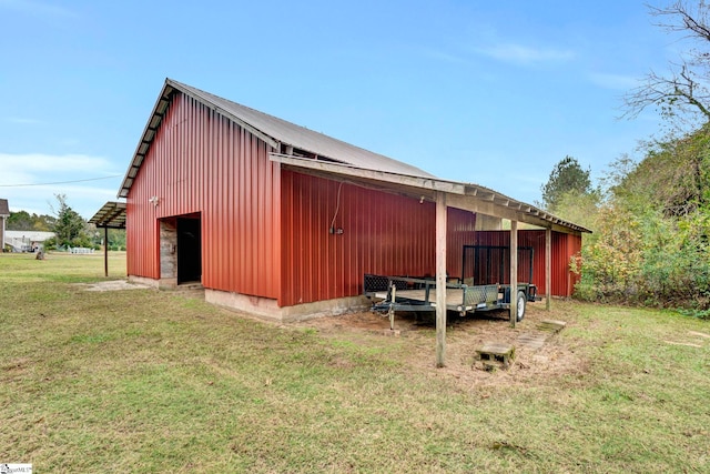 view of outbuilding featuring a lawn