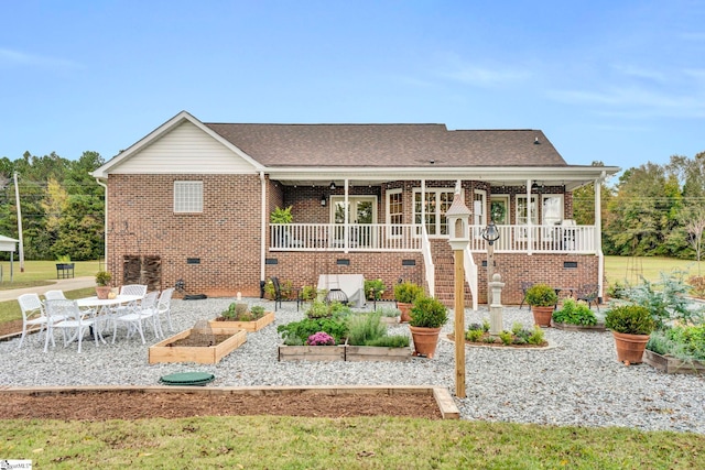 rear view of house featuring a porch, a patio, and a lawn