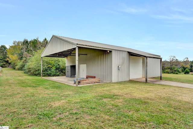 view of outbuilding with a yard and a garage