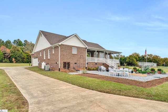 rear view of property with a lawn, a patio area, and covered porch