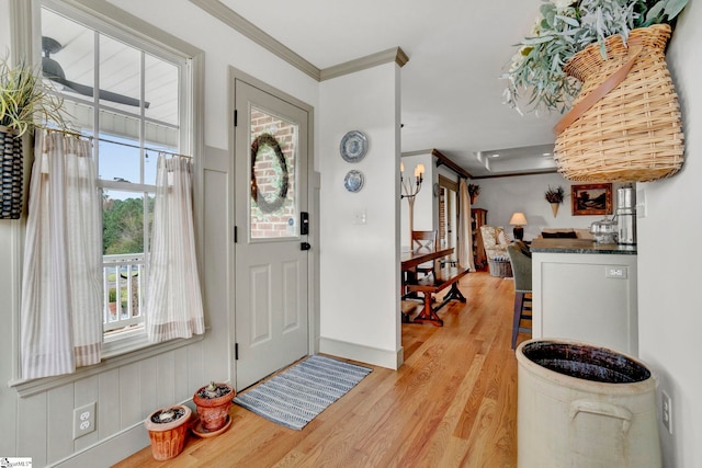 entrance foyer featuring light hardwood / wood-style flooring and crown molding