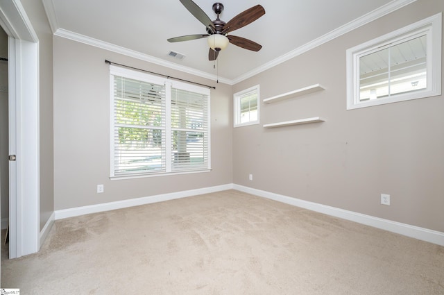 empty room with ornamental molding, light colored carpet, and ceiling fan