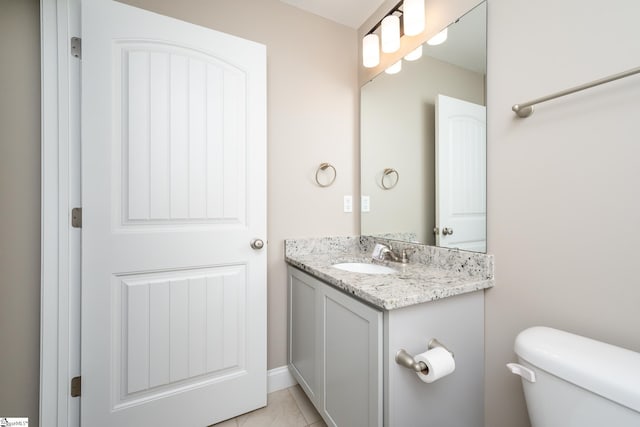 bathroom featuring vanity, toilet, and tile patterned floors