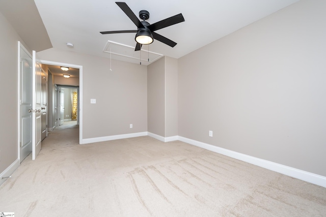 carpeted spare room with ceiling fan