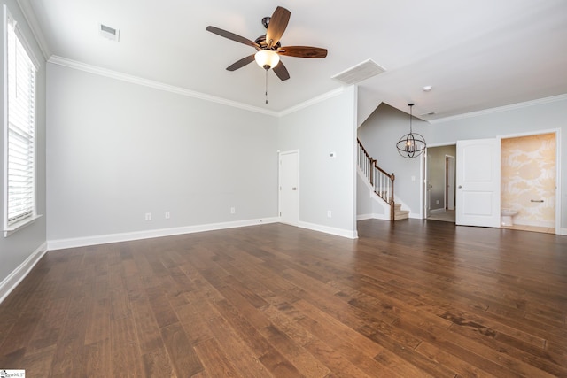 unfurnished living room with crown molding, a wealth of natural light, and dark hardwood / wood-style floors