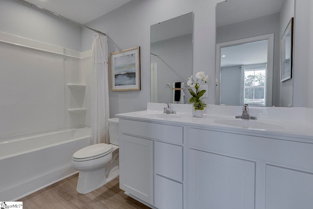 full bathroom featuring vanity, toilet, hardwood / wood-style flooring, and shower / bathtub combination with curtain