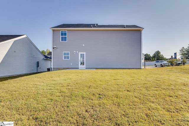 back of house with a yard