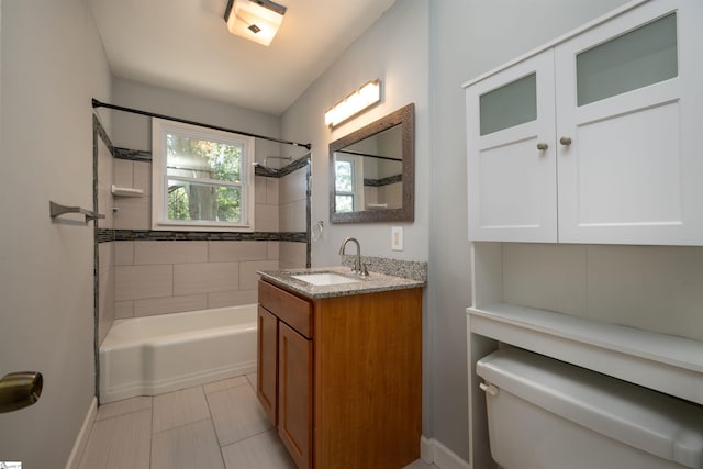 full bathroom featuring vanity, tiled shower / bath combo, toilet, and tile patterned floors