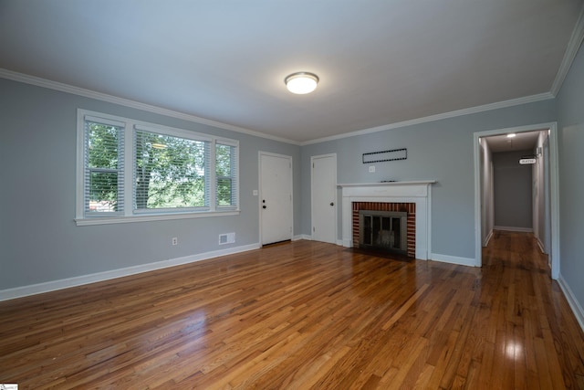 unfurnished living room with crown molding, hardwood / wood-style flooring, and a fireplace