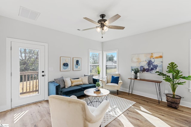 living room with a healthy amount of sunlight, light wood-type flooring, and ceiling fan