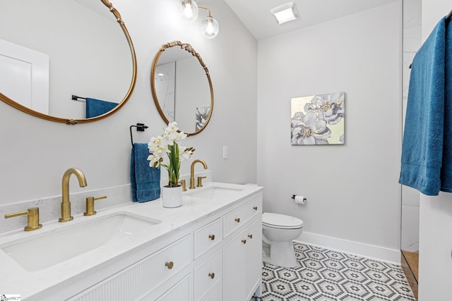 bathroom with vanity, toilet, and tile patterned floors