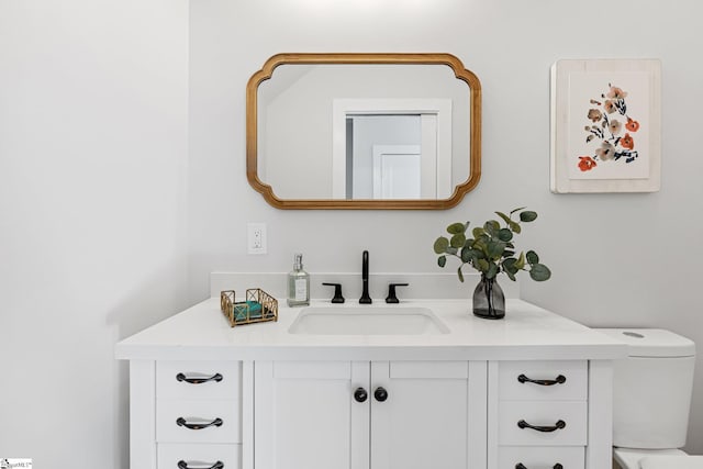 bathroom featuring vanity and toilet