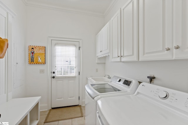 laundry area featuring cabinets, light tile patterned floors, separate washer and dryer, crown molding, and sink