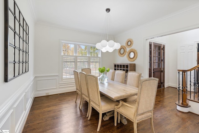 dining area with crown molding, dark hardwood / wood-style floors, and an inviting chandelier