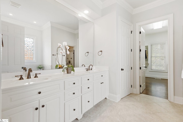 bathroom featuring vanity, crown molding, and hardwood / wood-style floors