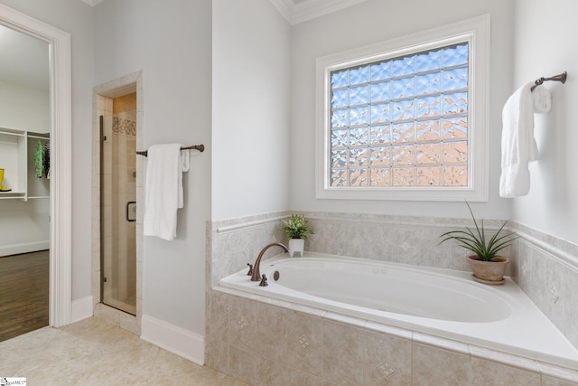 bathroom with ornamental molding, shower with separate bathtub, and tile patterned floors