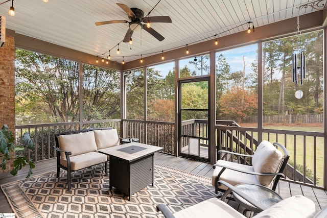 sunroom featuring ceiling fan