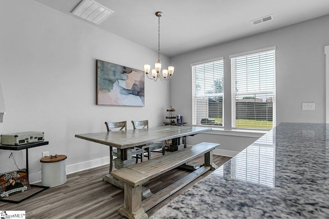 dining room with a chandelier and dark hardwood / wood-style floors