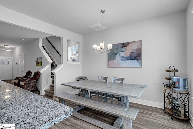 dining room featuring a notable chandelier and wood-type flooring