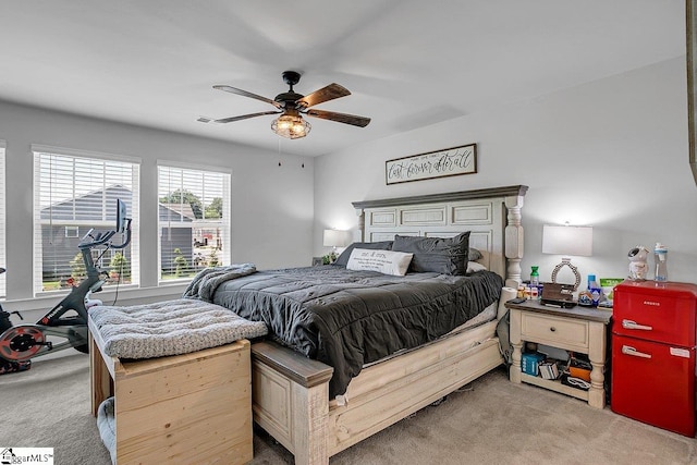 bedroom featuring light colored carpet and ceiling fan