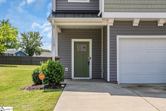 entrance to property featuring a lawn