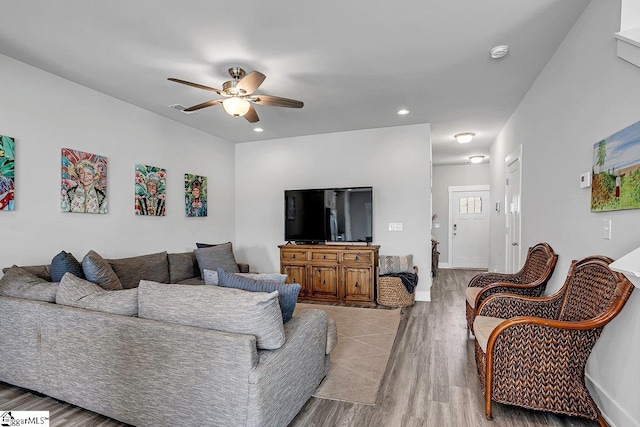 living room with light hardwood / wood-style floors and ceiling fan