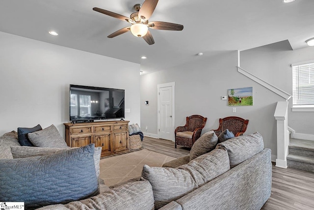 living room with ceiling fan and light hardwood / wood-style flooring