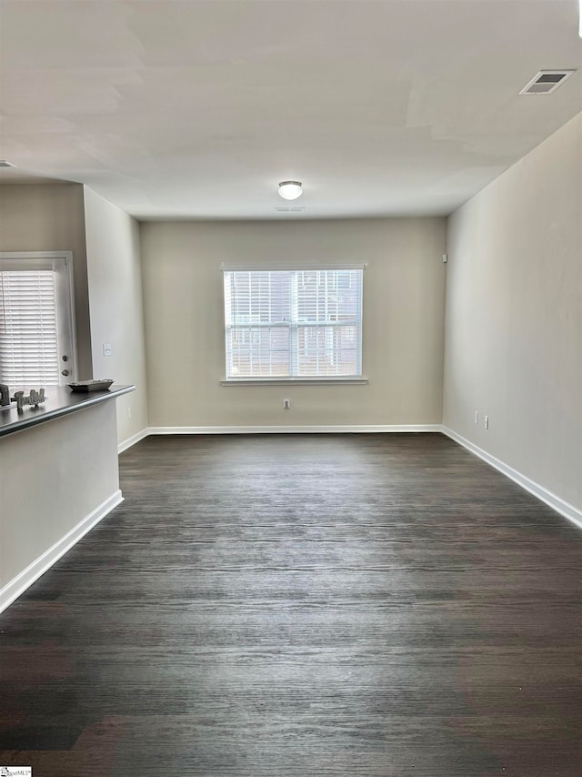 unfurnished living room featuring dark wood-type flooring