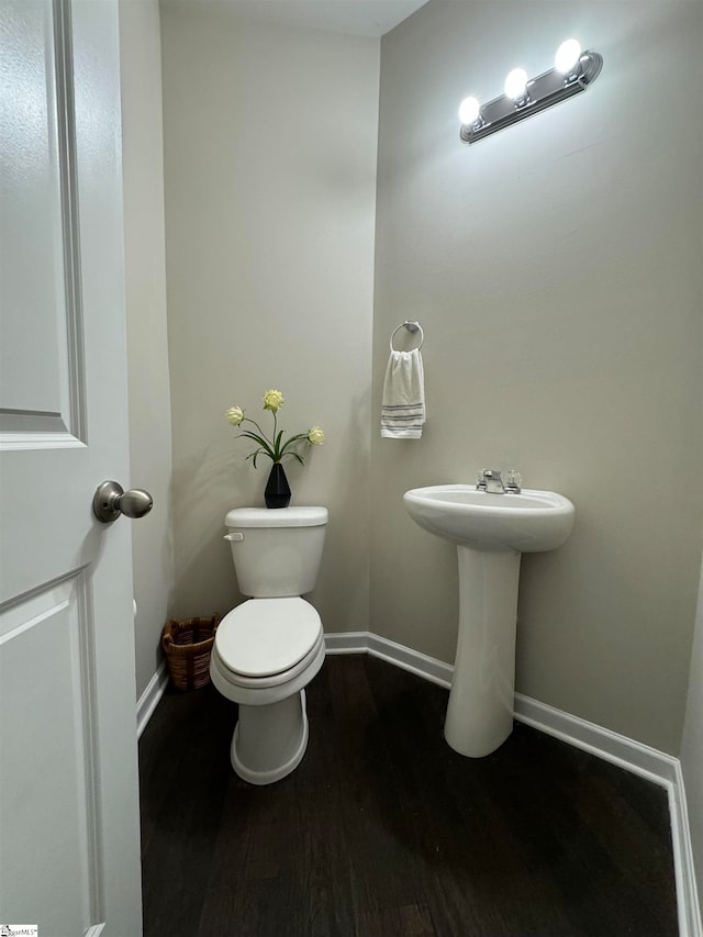 bathroom featuring toilet and hardwood / wood-style flooring