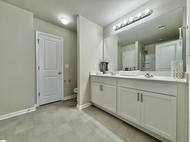 bathroom featuring vanity, toilet, and walk in shower