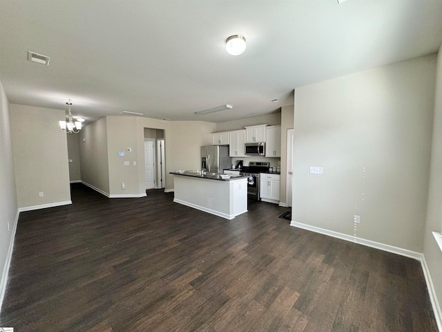 kitchen featuring white cabinets, an island with sink, appliances with stainless steel finishes, a chandelier, and dark hardwood / wood-style floors