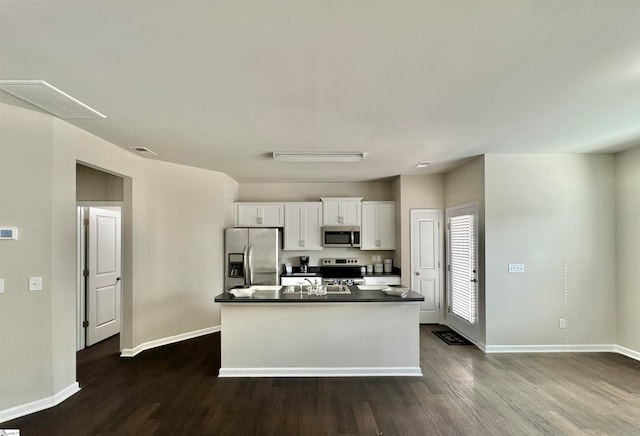 kitchen featuring white cabinetry, appliances with stainless steel finishes, dark hardwood / wood-style flooring, and a kitchen island