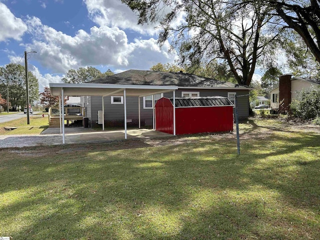 611 Shands St, Clinton, SC 29325 - rear view of house with a lawn, a storage shed, and a carport