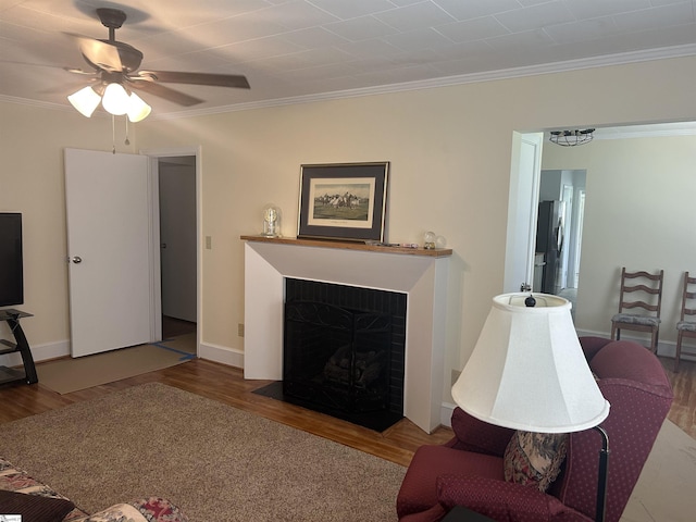 611 Shands St, Clinton, SC 29325 - living area featuring wood finished floors, crown molding, a ceiling fan, and a fireplace with flush hearth
