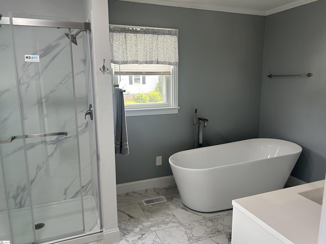 611 Shands St, Clinton, SC 29325 - bathroom with vanity, a marble finish shower, marble look tile flooring, a soaking tub, and crown molding