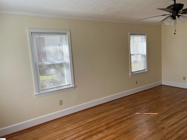 spare room featuring ceiling fan, crown molding, and hardwood / wood-style floors