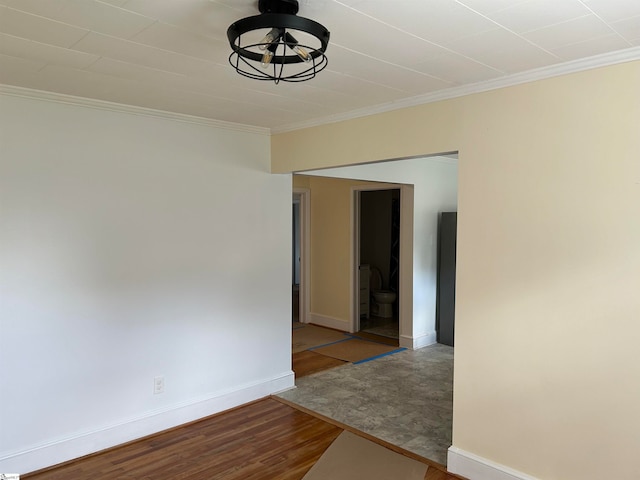 spare room featuring crown molding and hardwood / wood-style flooring