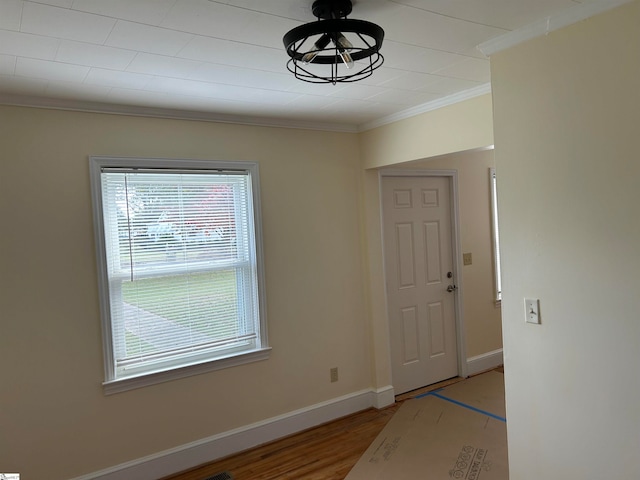 entrance foyer featuring ornamental molding and light wood-type flooring