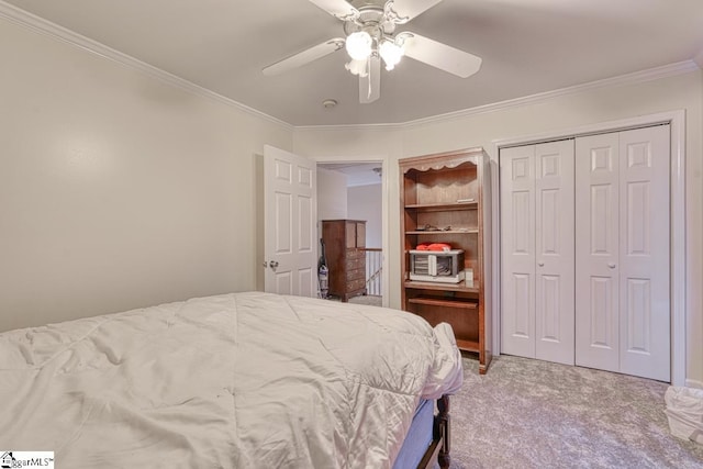 bedroom with a closet, ceiling fan, carpet flooring, and ornamental molding