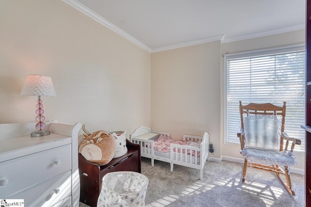 bedroom with crown molding, carpet floors, and a crib