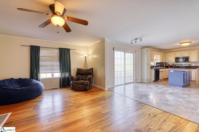 living room with crown molding, ceiling fan, plenty of natural light, and light wood-type flooring