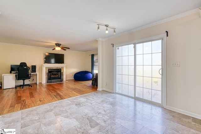 unfurnished living room with crown molding, light wood-type flooring, and ceiling fan