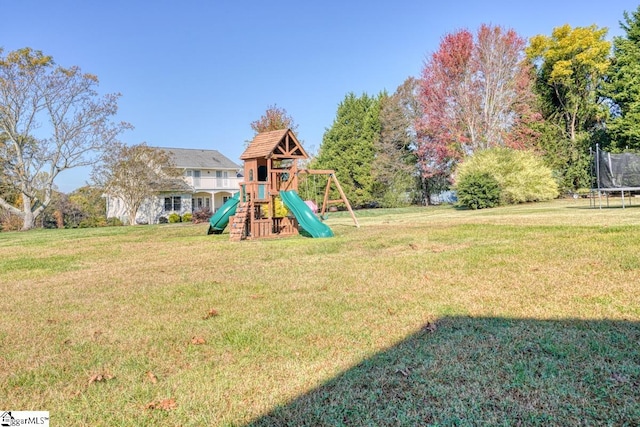 view of play area with a yard and a trampoline