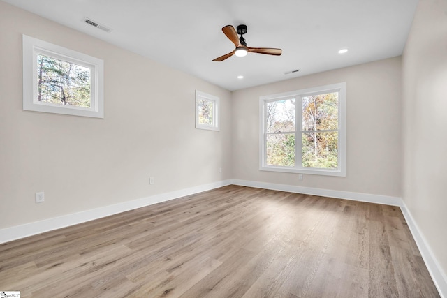 spare room with light hardwood / wood-style floors and ceiling fan